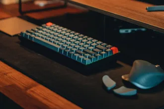 A black desk with a black MacBook Pro, mouse, and pen holder, creating a productive and stylish workspace.